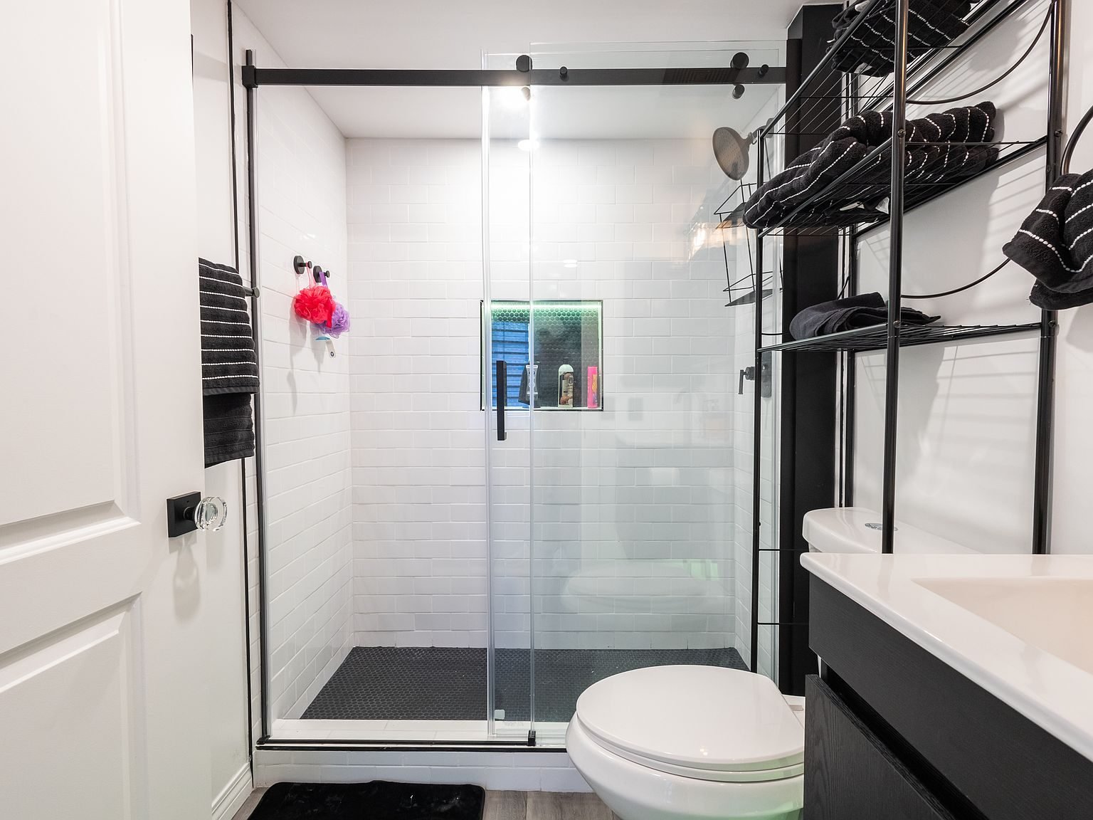 Walk-in glass shower with white tile in Apartment A