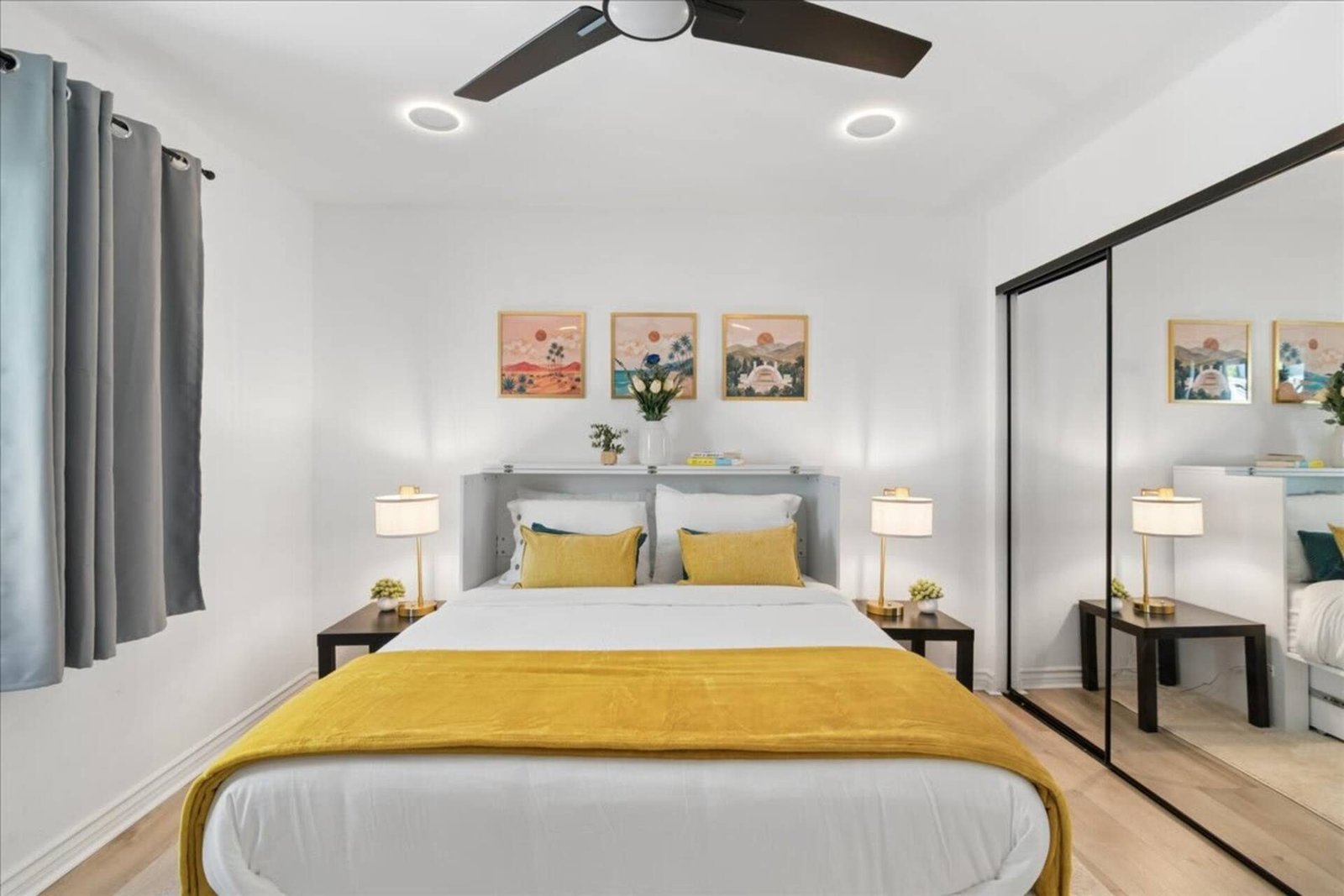 Bedroom with crisp white bedding and a yellow throw